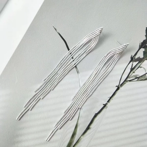 Long geometric chain tassel earrings in silver metal with elegant waterfall drop effect