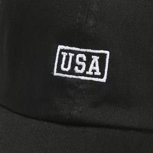 Close-up of high-quality USA letter embroidery and cotton twill texture on a black cap