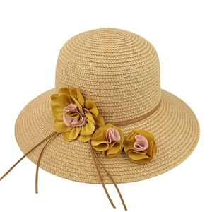 Handwoven straw sun hat for women with decorative flowers for summer beach and travel