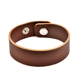 Close-up of textured brown PU leather bracelet with metallic snap fastener on white background