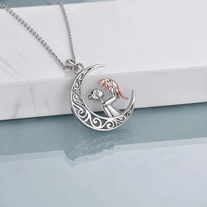 Detailed close-up of S925 silver hollow moon pendant with a girl and cat design