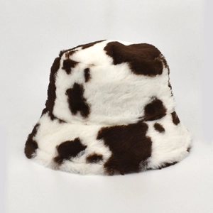Detailed view of plush faux fur texture on this cow print winter bucket hat