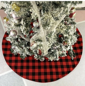 Close-up of red and black buffalo plaid Christmas tree skirt decoration under the tree