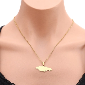 Jamaica map outline pendant necklace in gold finish shown worn on a neck model