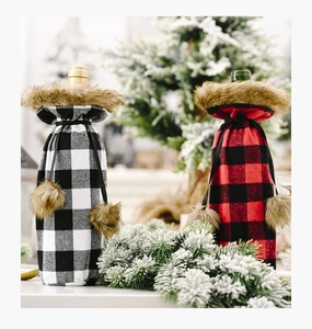 Detail of red and white buffalo plaid wine bottle covers with faux fur collars and pom-poms