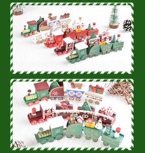 Detailed view of wooden Christmas train ornaments with Santa and snowman on snow