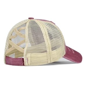 Washed purple criss-cross ponytail trucker hat with mesh back and velcro strap closure