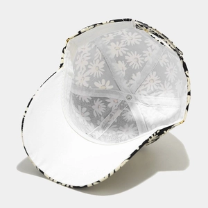 Detailed interior of a baseball cap with daisy print and white mesh lining reinforcement