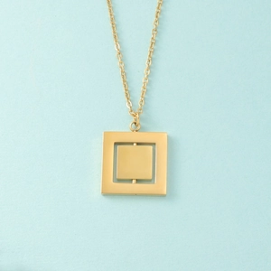 Detail of a rotating double-layer geometric square pendant necklace in gold finish