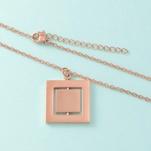 Detail of rose gold spinning square pendant with lobster clasp and adjustable chain
