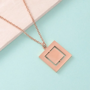 Detailed view of rose gold rotatable double-layer square pendant on geometric necklace