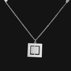 Close-up of rotating double-layer geometric square pendant necklace in silver stainless steel