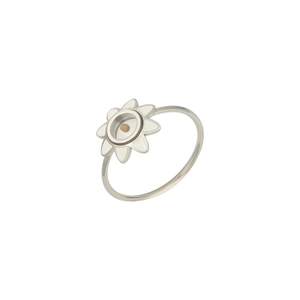 Macro view of silver stainless steel ring with white enamel flower petals and yellow center