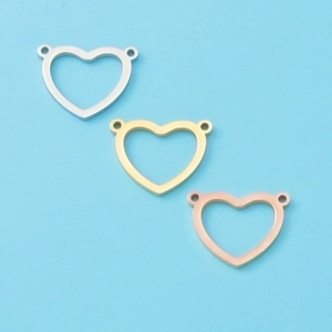 Detail of heart-shaped pendants in silver, gold, and rose gold with double loops