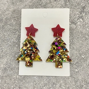 Close-up of glitter acrylic Christmas tree earrings featuring stars and festive colors