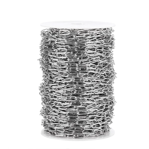 Macro shot of 7mm silver stainless steel oval link chain on white plastic spool