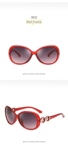 Detail view of red oversized sunglasses with gradient lenses and silver metal temple decor