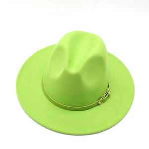 Detail of bright green wool fedora hat featuring flat brim and gold buckle strap
