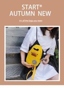 Detail of cute yellow cartoon duck canvas crossbody bag with 3D beak and wing features