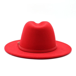 Close-up of a red wool fedora hat with a matching leather band and metal buckle detail