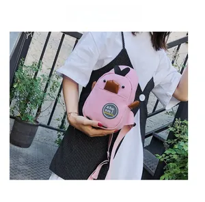 Detailed view of pink canvas duck chest bag showing the 3D beak and badge detail