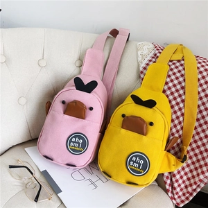 Detail showing pink and yellow cartoon duck canvas chest bags with 3D duckling features