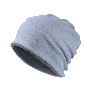 Close-up of light grey knitted beanie with soft cotton texture and detailed stitching