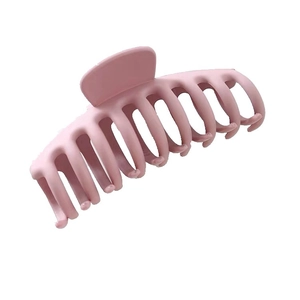 Detailed view of the large pink plastic hair claw clip on a clean white background
