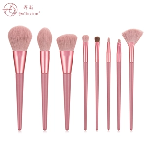 Detail of 9-piece pink makeup brush set with synthetic bristles and glossy handles