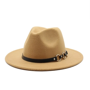 Detail of khaki wool fedora hat with black faux leather band and silver metal rings
