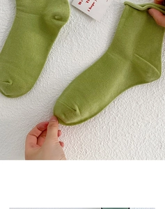 Detail shot of green cotton slouch socks showing high stretch and knit texture