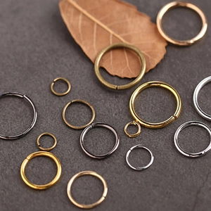Macro shot of assorted metal jump rings in gold, silver and bronze for jewelry making