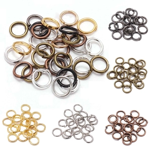 Assorted DIY jewelry jump rings in multiple metallic finishes on a white background