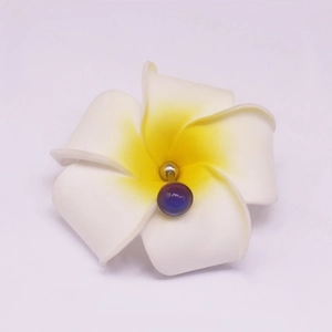 Detailed view of stainless steel tongue ring with realistic white frangipani flower and purple bead