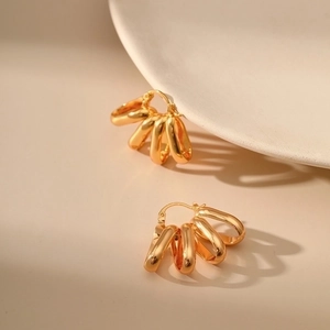 Minimalist 18K gold-plated multi-layer hoop earrings shown in a premium aesthetic close-up
