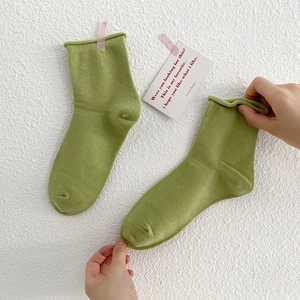 Women's cotton slouch socks in grass green with minimalist rolled edge design