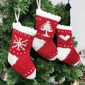 Set of 3 red and white knitted Christmas stockings with snowflake and heart patterns