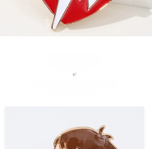 Detailed view of colorful enamel pins featuring a lightning heart and cartoon character