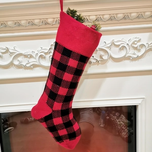 Classic 18 inch red and black plaid knitted Christmas stocking with pine and berry decor