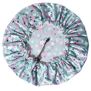 Macro detail of floral satin shower cap featuring PEVA lining and adjustable drawstring