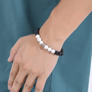 Zodiac set with natural white turquoise and lava stone beads on a model's wrist