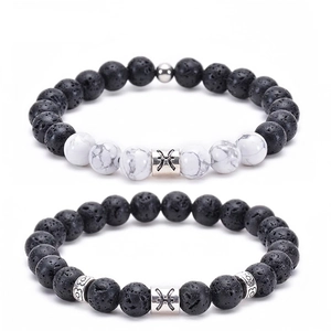 Detail of Pisces set with black volcanic lava stones, white turquoise and silver charms