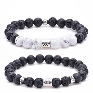 Close-up of Aquarius zodiac bracelet set with white turquoise and black lava stone beads