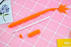 Disassembled orange maple leaf silicone gel pen showing pen body, refill, and cap detail