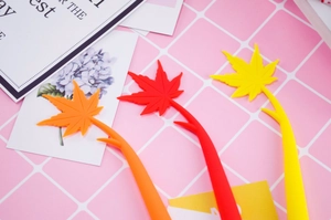 Close-up of silicone maple leaf bookmarks in vibrant red, orange, and yellow hues