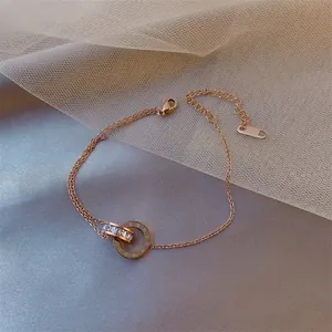 Rose gold chain bracelet featuring interlocking rings with Roman numerals and crystals