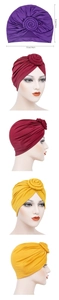 Detail view of colorful pleated donut turban hats with top floral knot and size dimensions