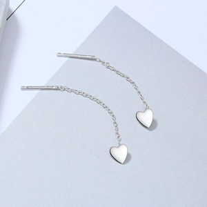 Detailed close-up of S925 sterling silver heart tassel earrings showing the engraved hallmark