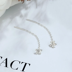 Close-up of S925 sterling silver hallmarked earring chain with a delicate flower charm