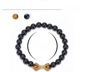 Detail of 8mm matte black agate and tiger eye beaded bracelet with gold claw charm